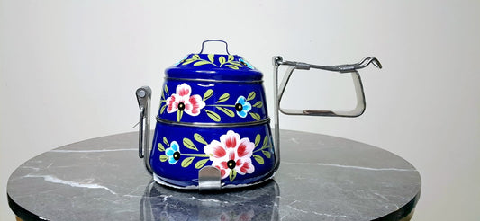 Decorative blue Tiffin with floral patterns on it