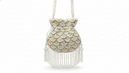 Decorative handbag with intricate design and white fringes on a white background