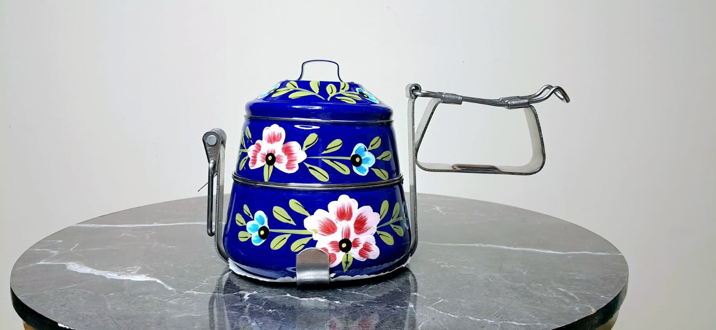 Decorative blue Tiffin with floral patterns on it
